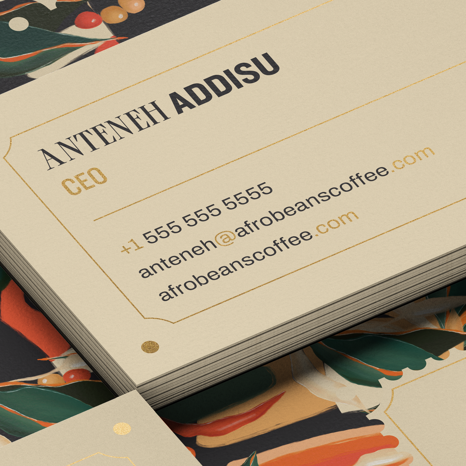 Cream business cards with gold foil type on a botanical surface