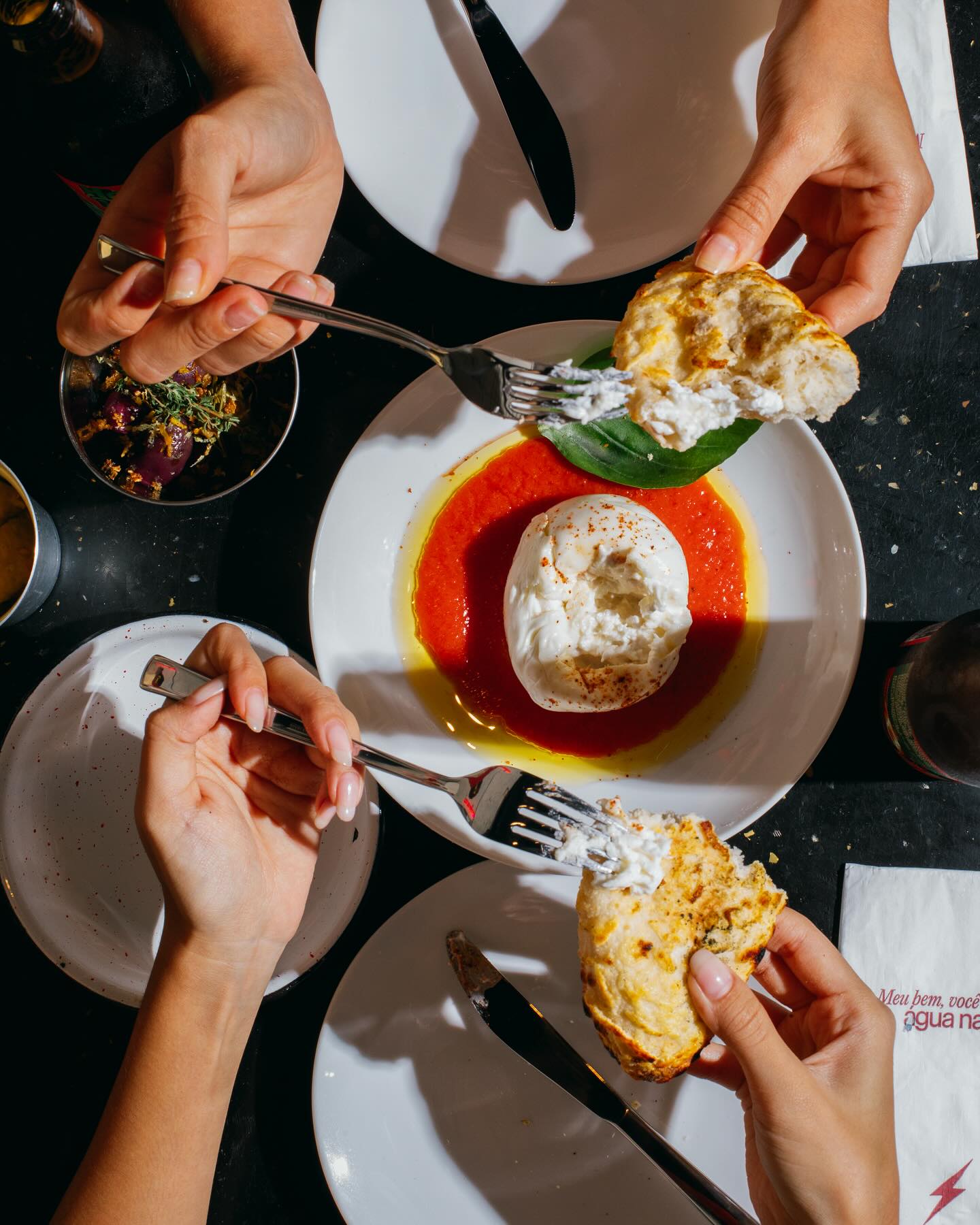 Sharing burrata with a branded napkin
