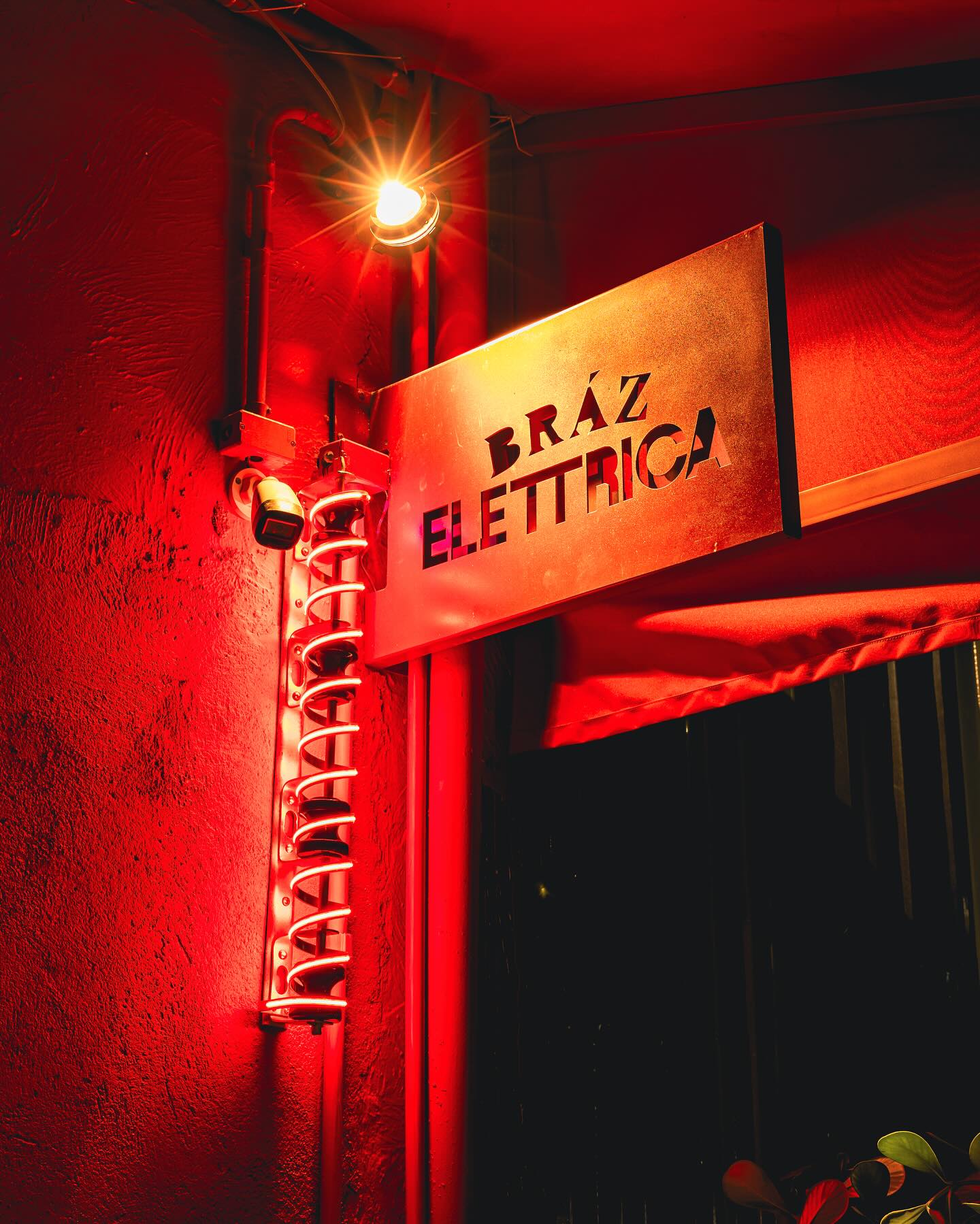 Exterior metal sign and coiled red neon